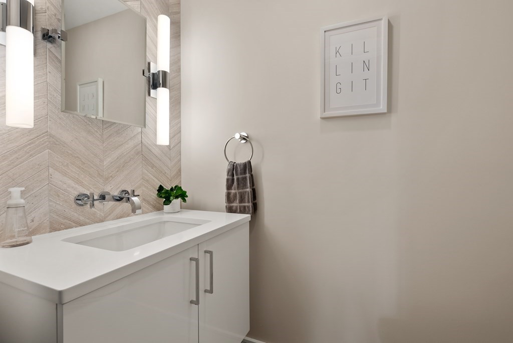 110 Broad Street, Unit 401 Boston, MA 02110 - Photo 19 of 24 a bathroom with a sink and a mirror