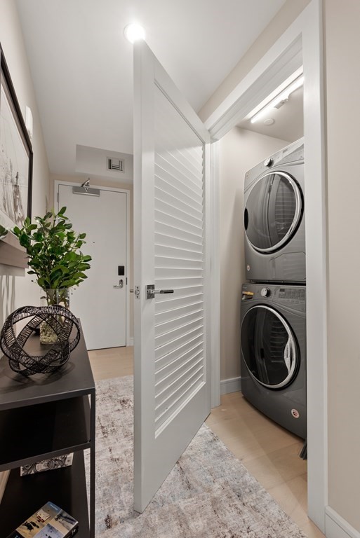 110 Broad Street, Unit 401 Boston, MA 02110 - Photo 20 of 24 a view of a hallway with washer and dryer