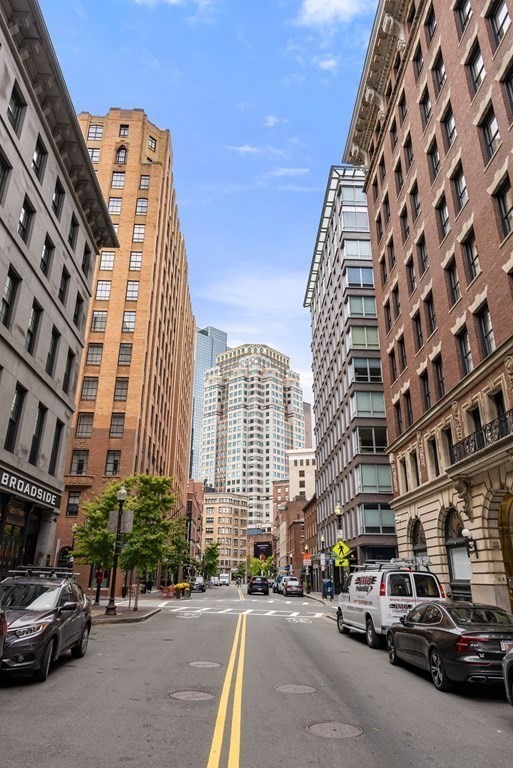 110 Broad Street, Unit 401 Boston, MA 02110 - Photo 23 of 24 a city street lined with parked cars and buildings