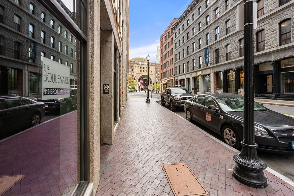 110 Broad Street, Unit 401 Boston, MA 02110 - Photo 24 of 24 a city street lined with parked cars and buildings