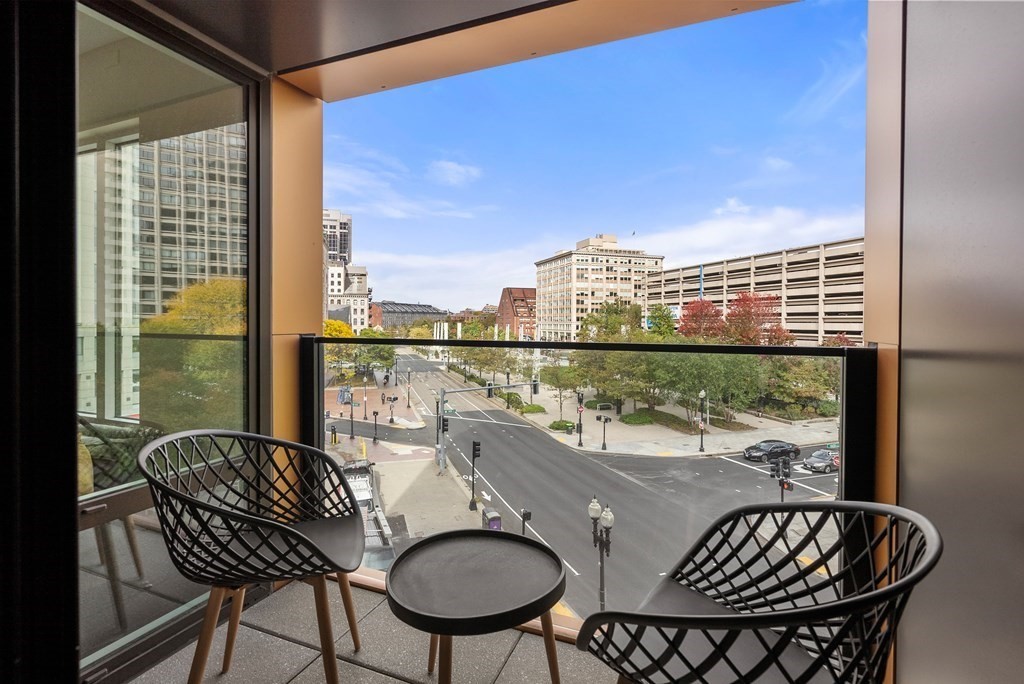 110 Broad Street, Unit 401 Boston, MA 02110 - Photo 3 of 24 a balcony view with a large window and wooden floor