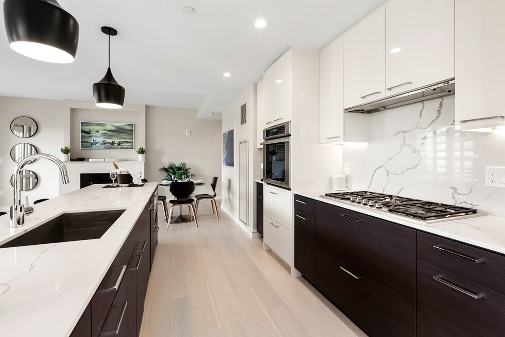 110 Broad Street, Unit 401 Boston, MA 02110 - Photo 5 of 24 a kitchen with stainless steel appliances a sink stove and refrigerator