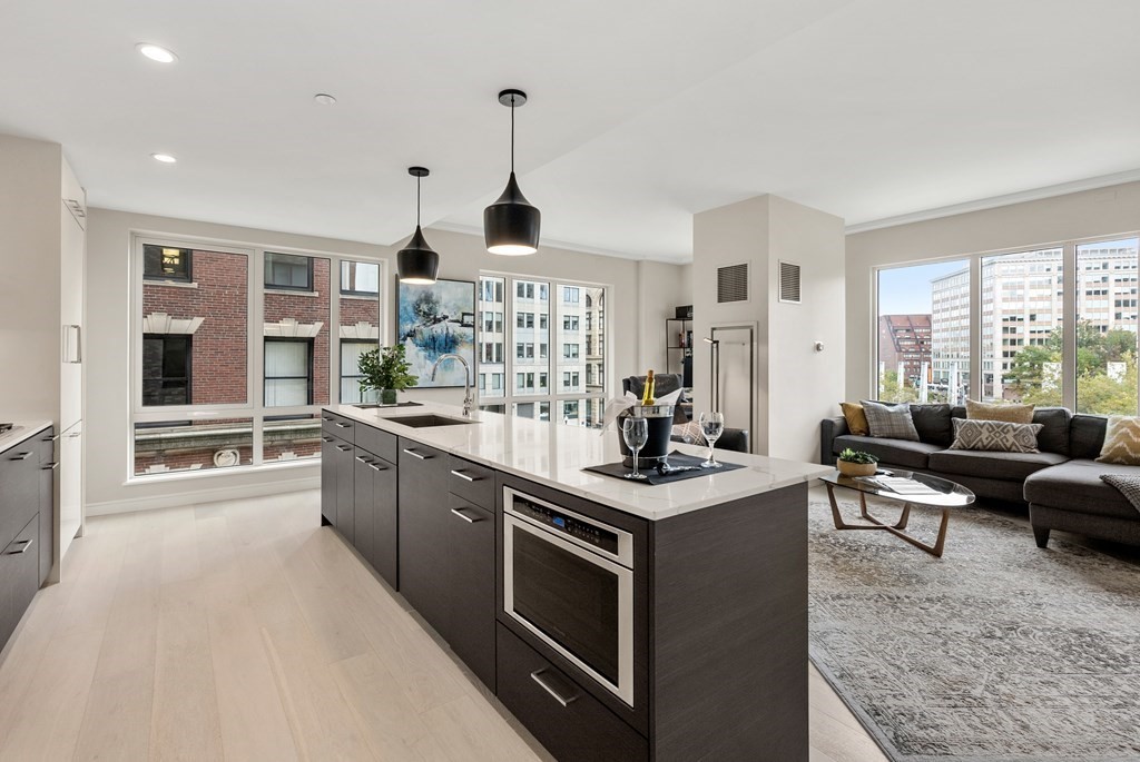 110 Broad Street, Unit 401 Boston, MA 02110 - Photo 6 of 24 a kitchen with stainless steel appliances granite countertop a stove and a sink