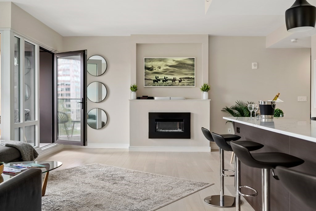 110 Broad Street, Unit 401 Boston, MA 02110 - Photo 9 of 24 a living room with furniture and a fireplace