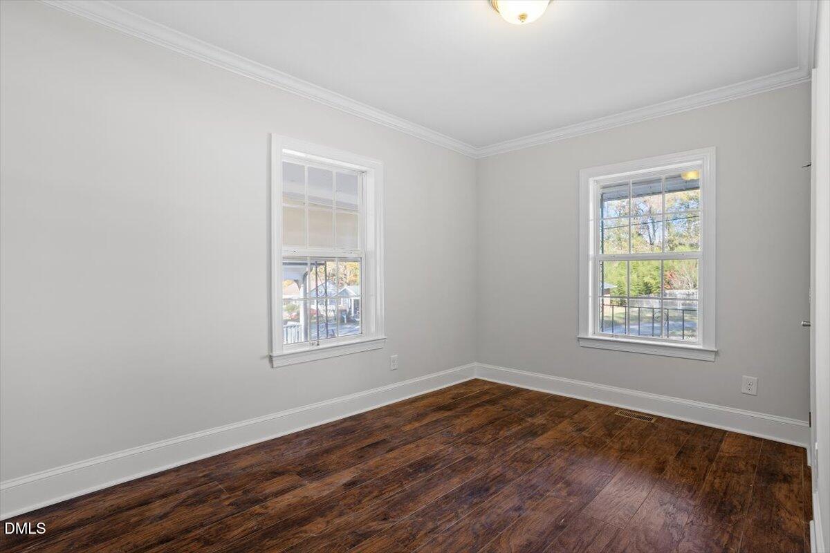 2618 Sater Street Durham, NC 27703 - Photo 18 of 27 an empty room with wooden floor and windows