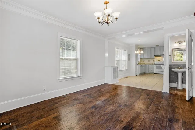 a view of an empty room with a kitchen