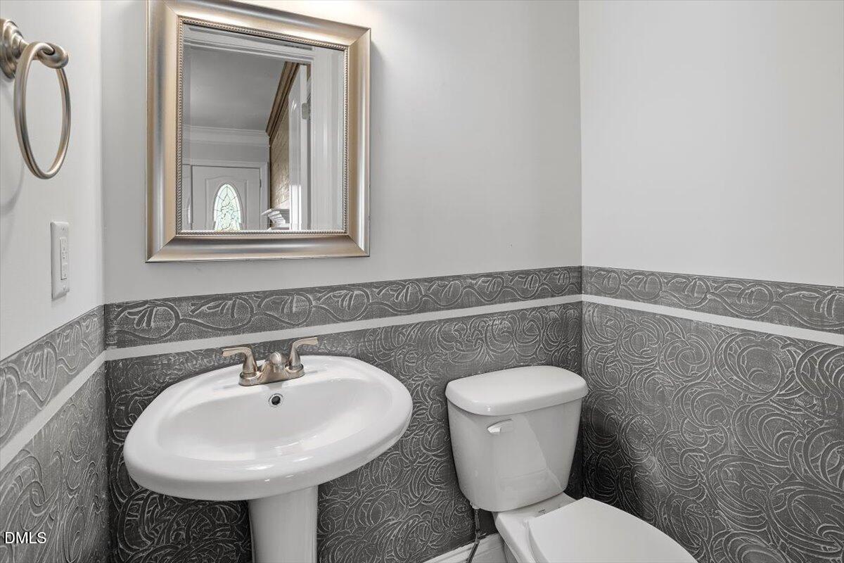 2618 Sater Street Durham, NC 27703 - Photo 9 of 27 a bathroom with a toilet sink and mirror