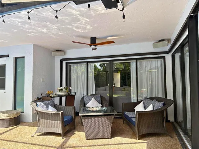 a living room with furniture and large window