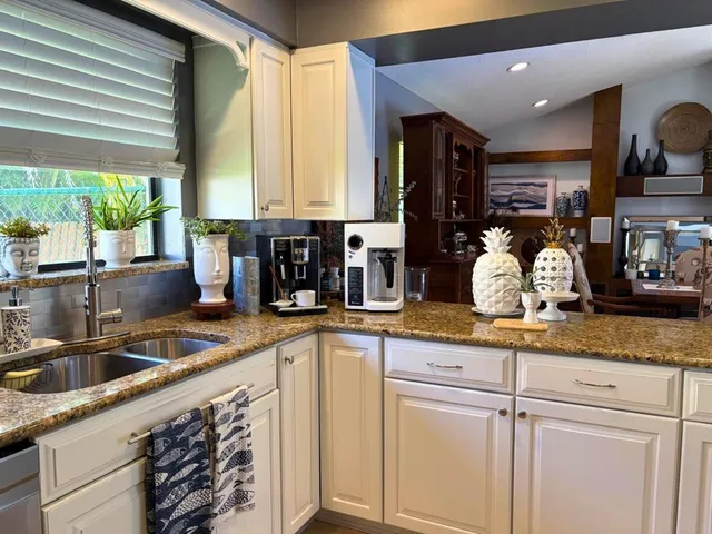 a kitchen with sink and cabinets