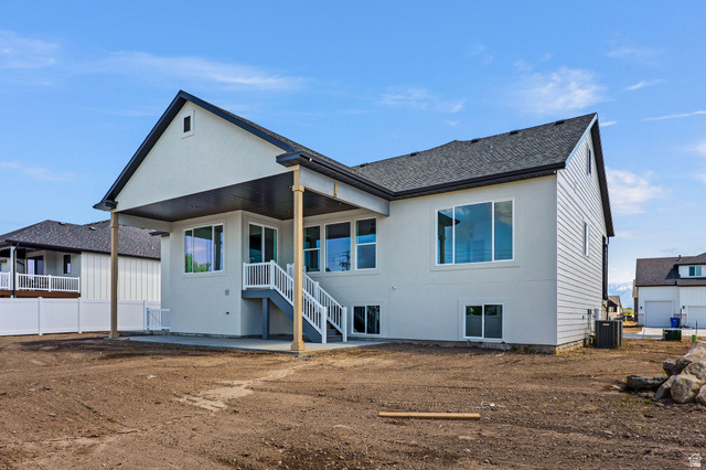 1144 South 4475 West West Point, UT 84015 - Photo 30 of 30 Rear exterior with a covered patio, composite deck stairs, and multiple large windows
