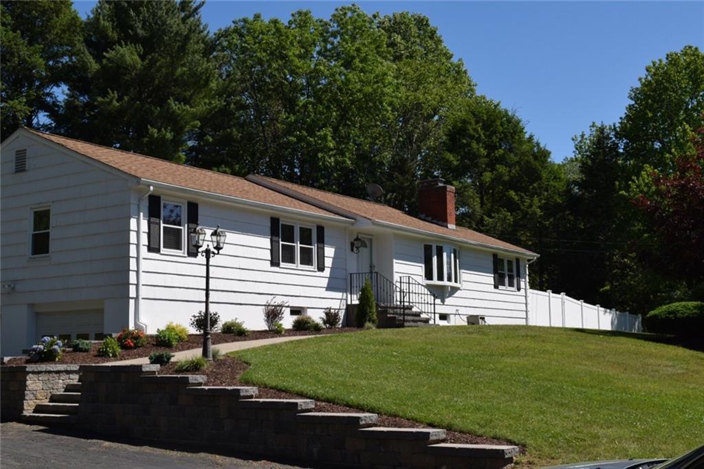 567 Grassy Hill Road Orange, CT 06477 - Photo 1 of 1 a front view of a house with a garden