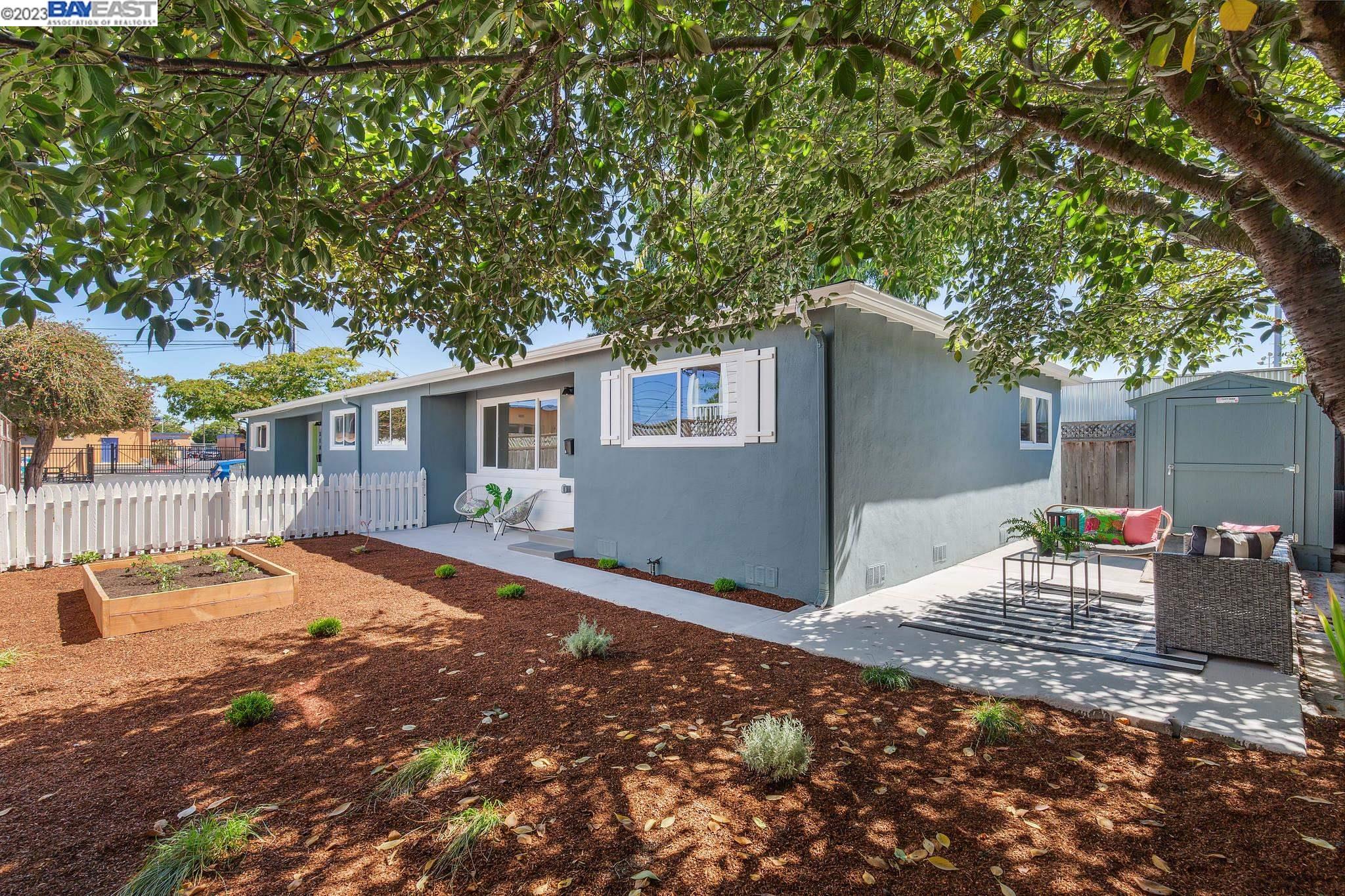 a backyard of a house with table and chairs