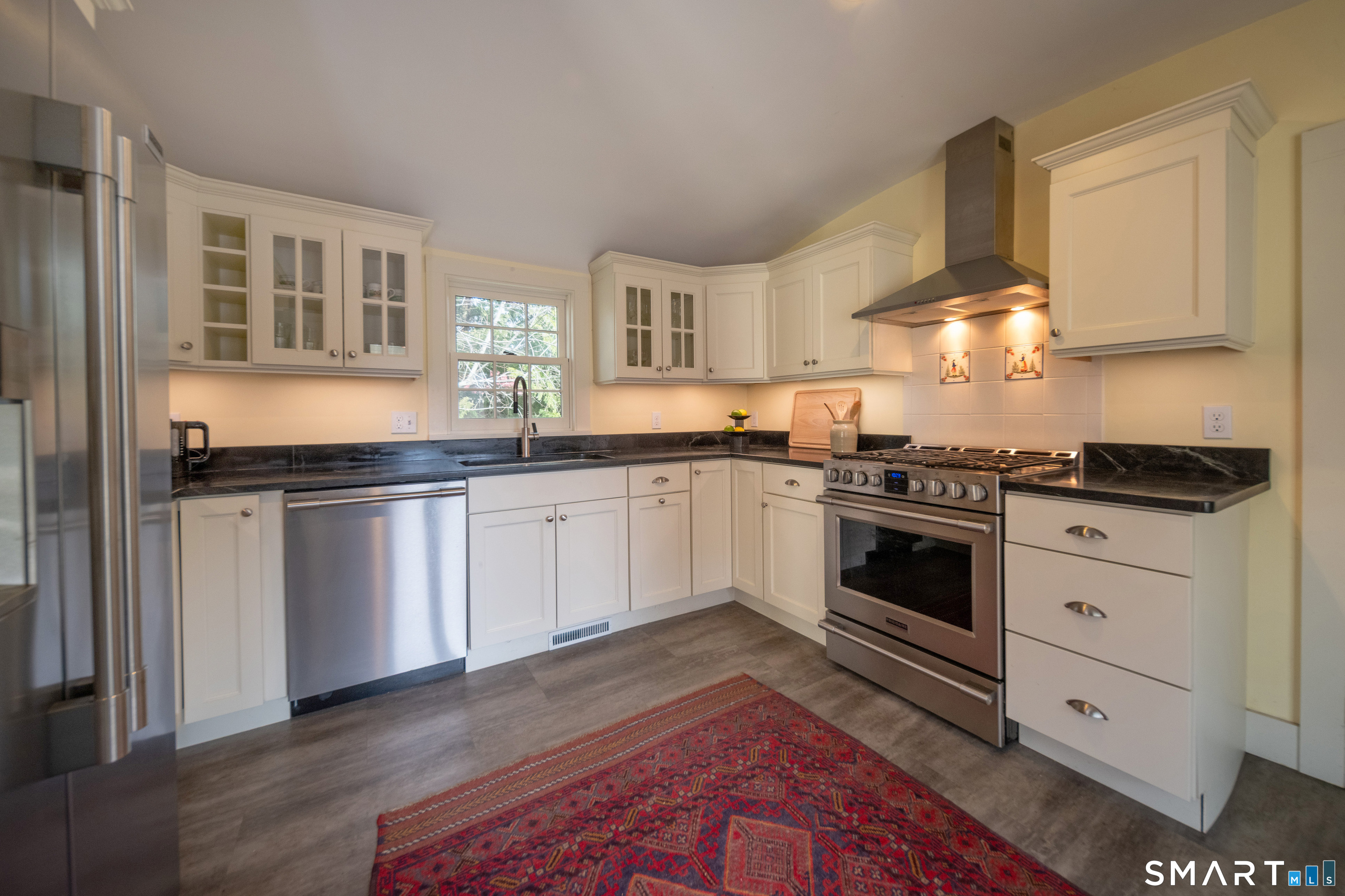 95 Fair Street Guilford, CT 06437 - Photo 13 of 40 a white kitchen with granite countertop a stove top oven