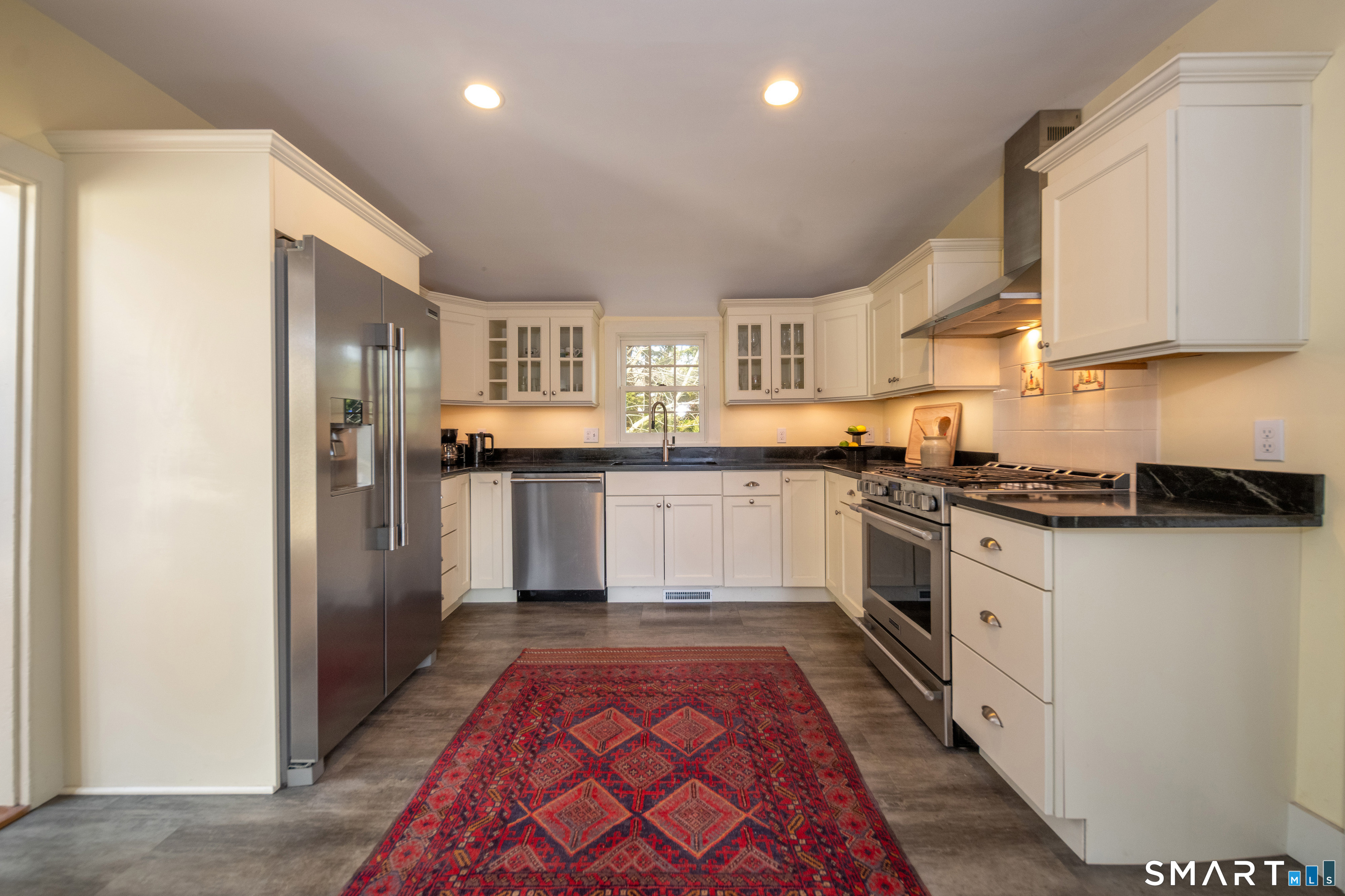 95 Fair Street Guilford, CT 06437 - Photo 15 of 40 a kitchen with stainless steel appliances granite countertop a refrigerator and a stove top oven