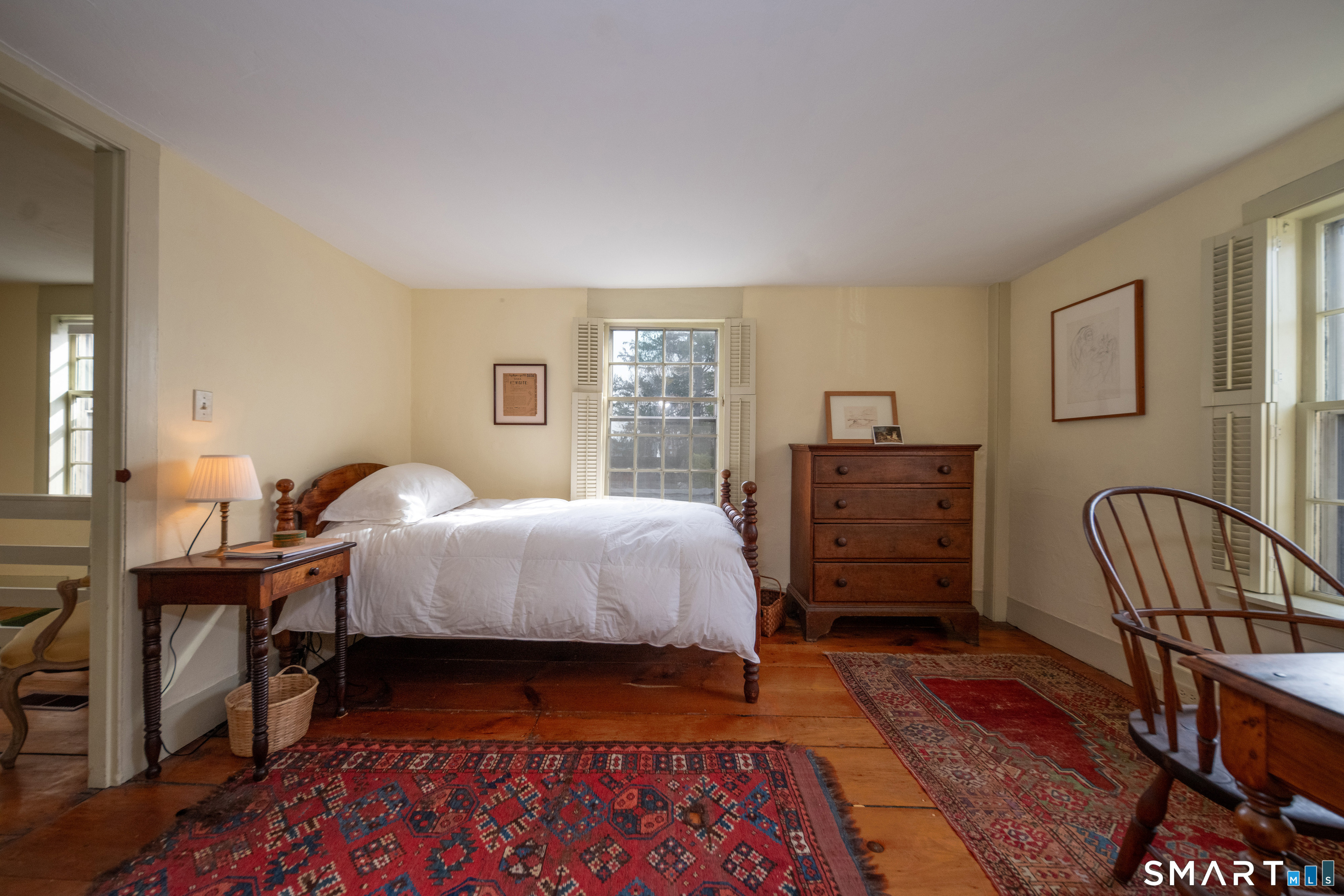 95 Fair Street Guilford, CT 06437 - Photo 21 of 40 a bedroom with a bed a dresser with wooden floor