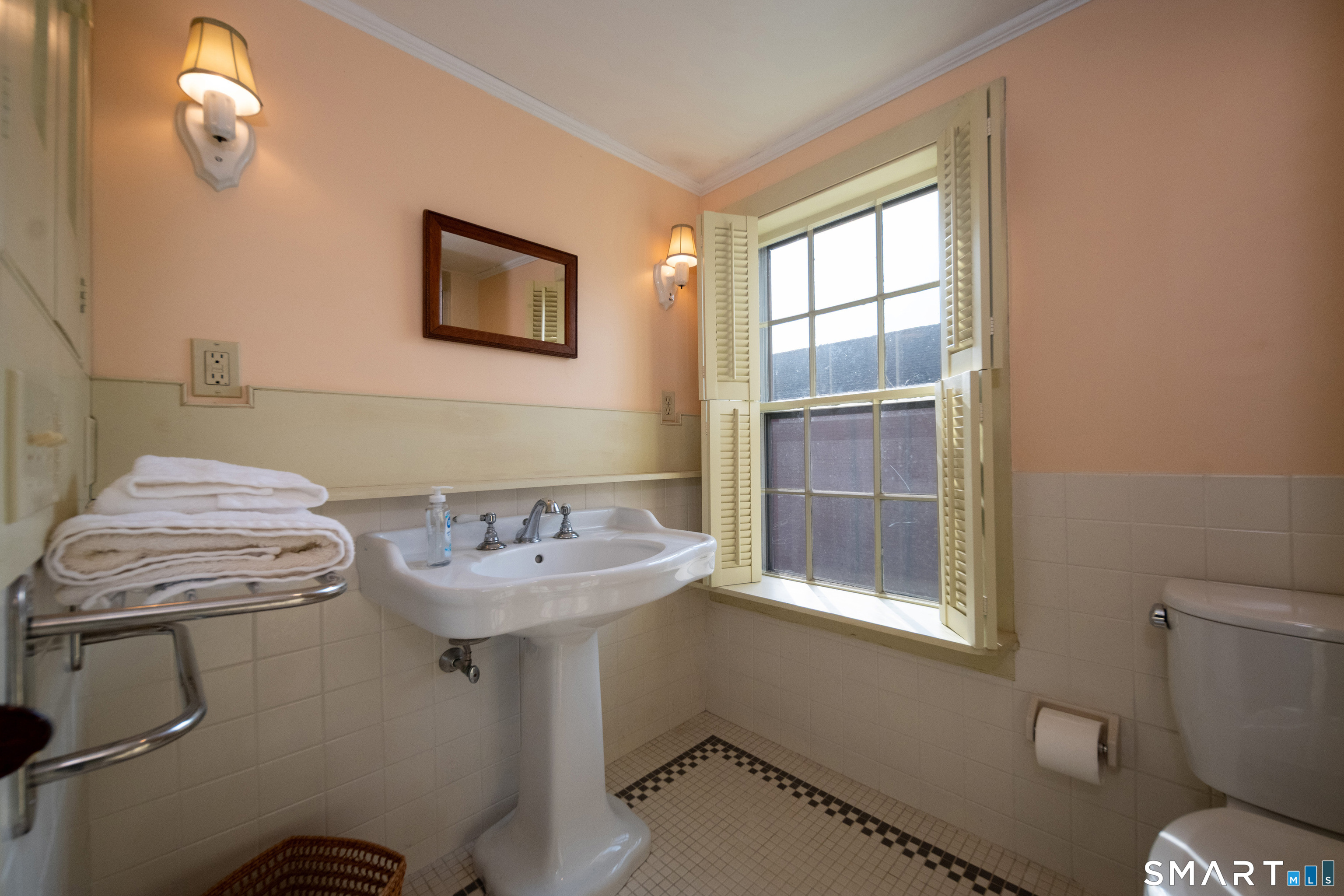 95 Fair Street Guilford, CT 06437 - Photo 23 of 40 a bathroom with a sink a toilet and a window