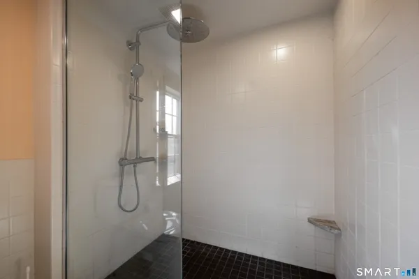 a bathroom with a glass shower door