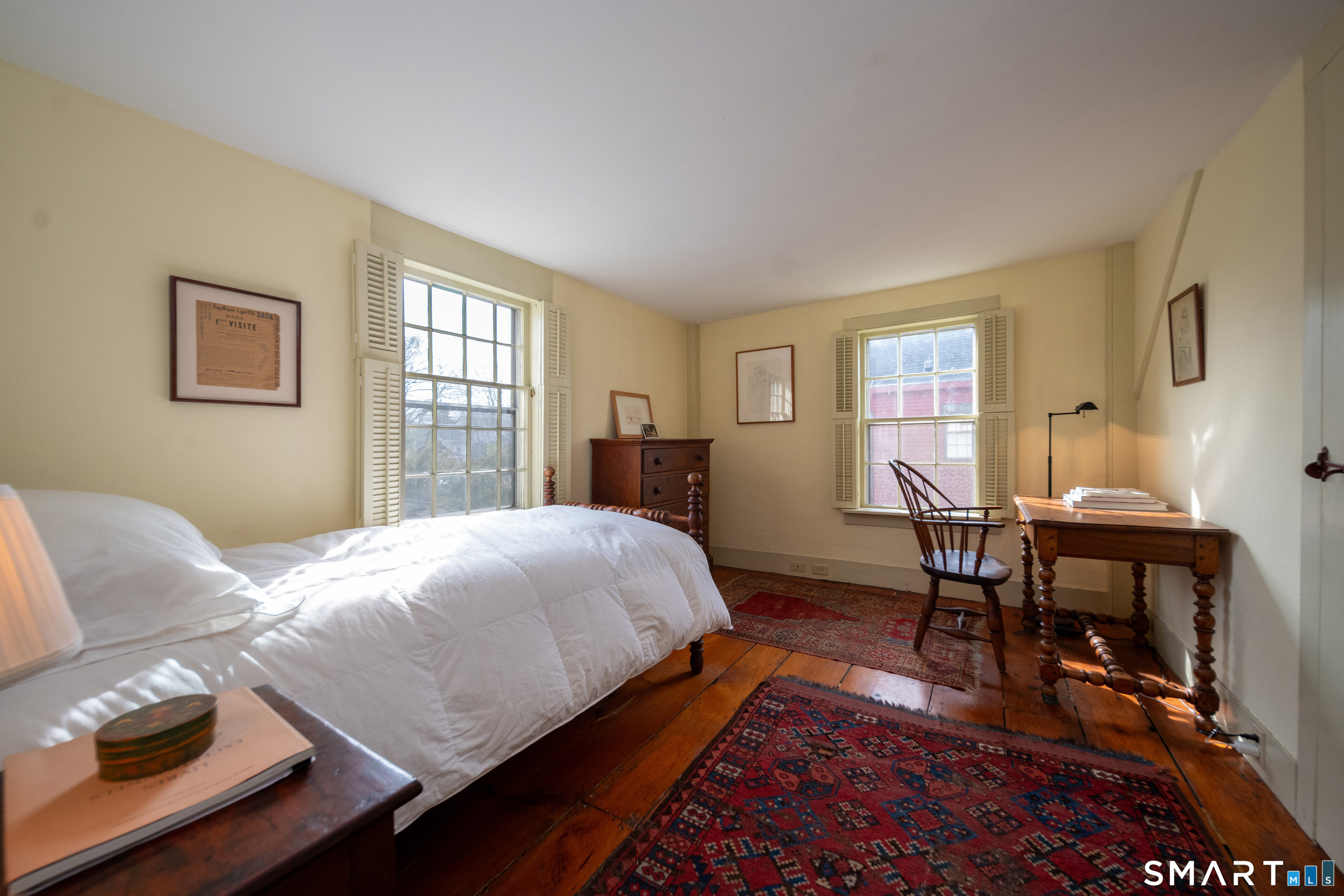 95 Fair Street Guilford, CT 06437 - Photo 25 of 40 a bedroom with a bed a table and a dresser next to a window