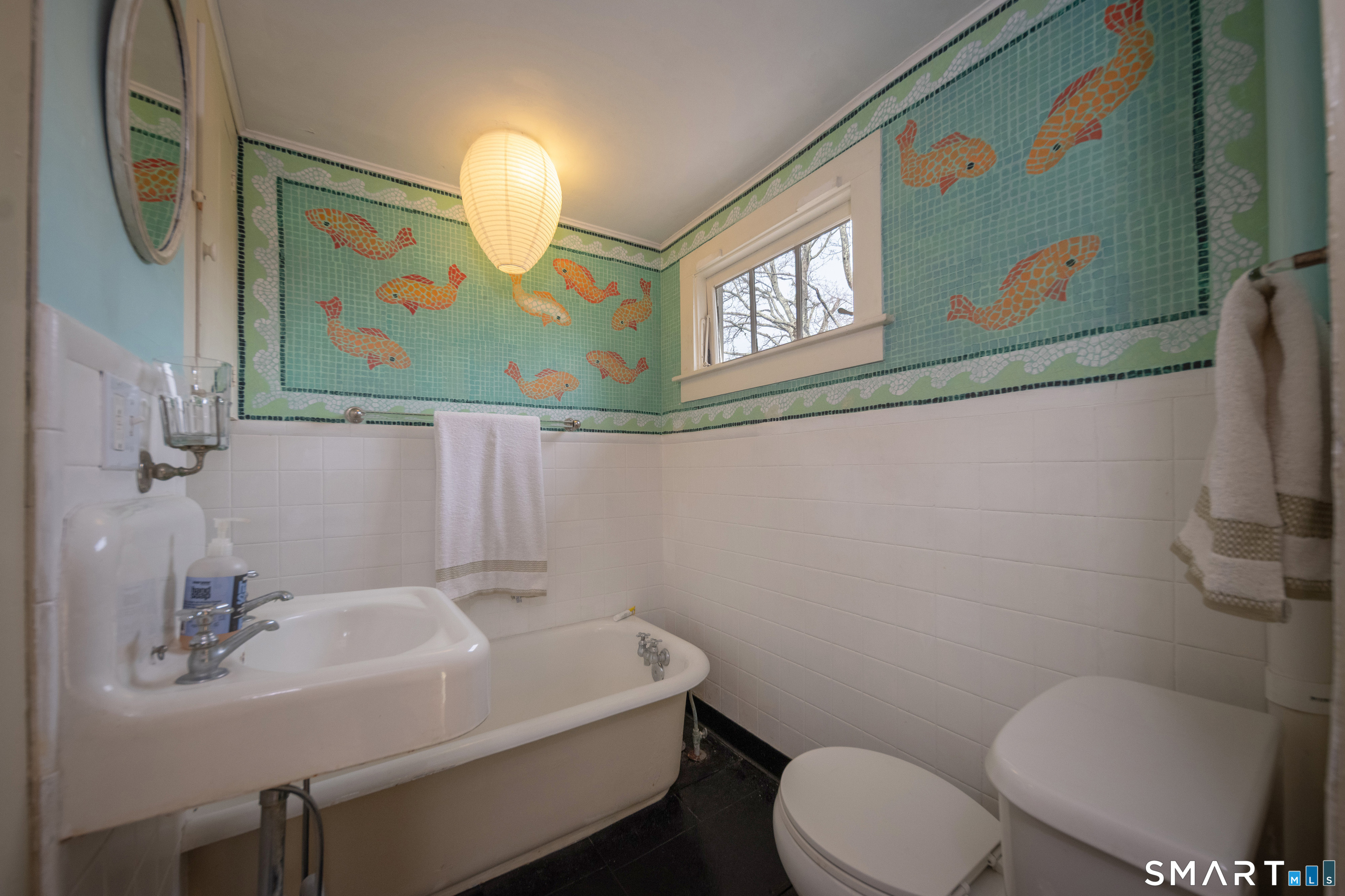 95 Fair Street Guilford, CT 06437 - Photo 27 of 40 a bathroom with a toilet a sink and mirror