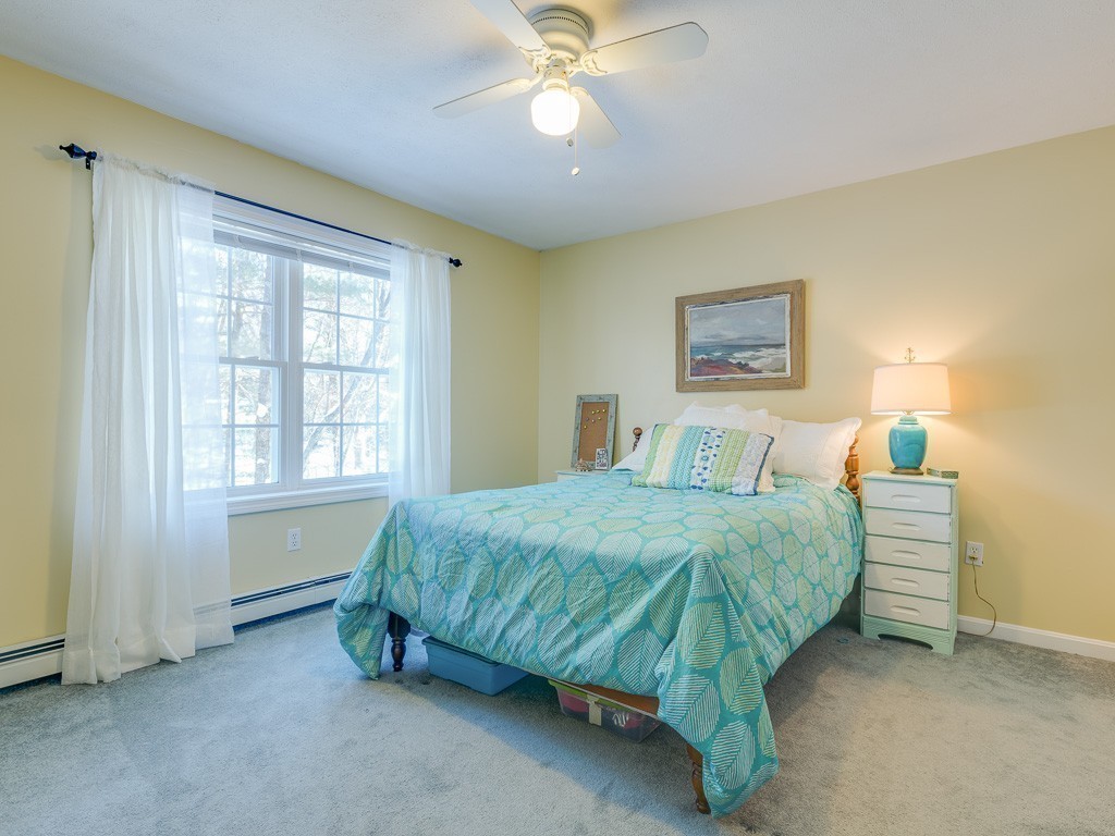 58 Mixter Road Holden, MA 01520 - Photo 21 of 30 a spacious bedroom with a bed and a chandelier