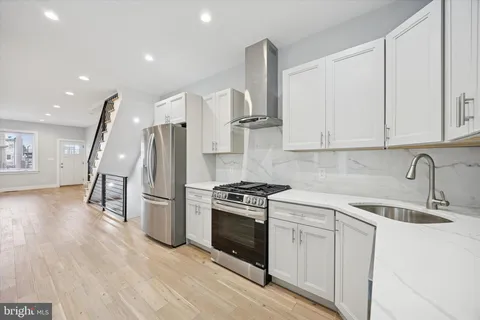 a kitchen with a stove a sink and a refrigerator