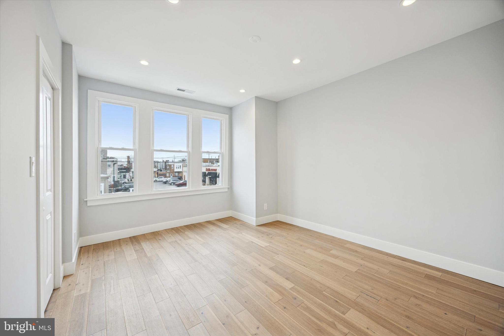 2869 Aramingo Avenue Philadelphia, PA 19134 - Photo 14 of 25 a view of an empty room with a window and wooden floor
