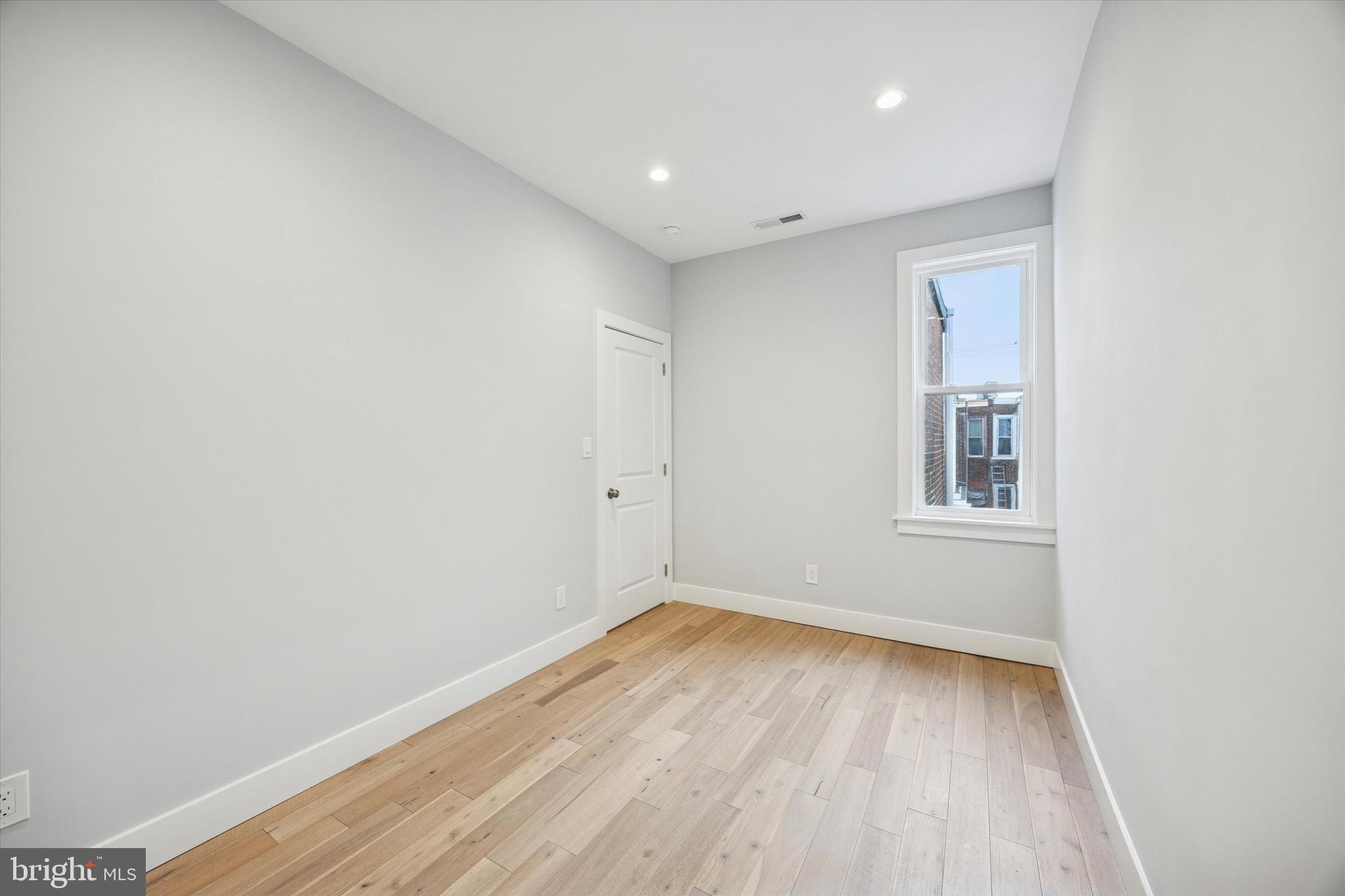2869 Aramingo Avenue Philadelphia, PA 19134 - Photo 17 of 25 a view of empty room with wooden floor and fan