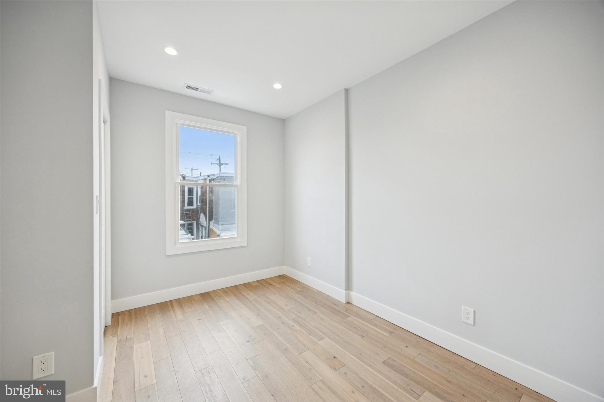 2869 Aramingo Avenue Philadelphia, PA 19134 - Photo 18 of 25 a view of an empty room with wooden floor and a window