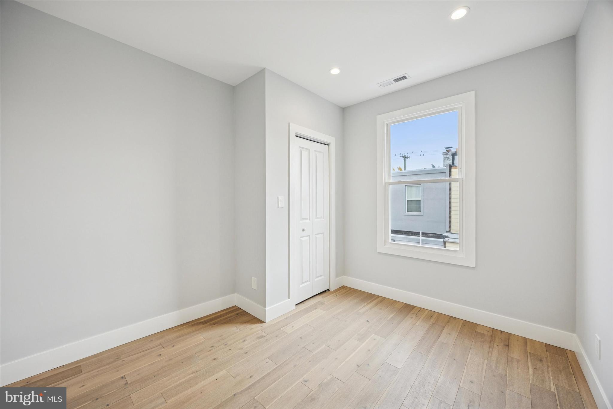 2869 Aramingo Avenue Philadelphia, PA 19134 - Photo 19 of 25 an empty room with a hardwood and hallway