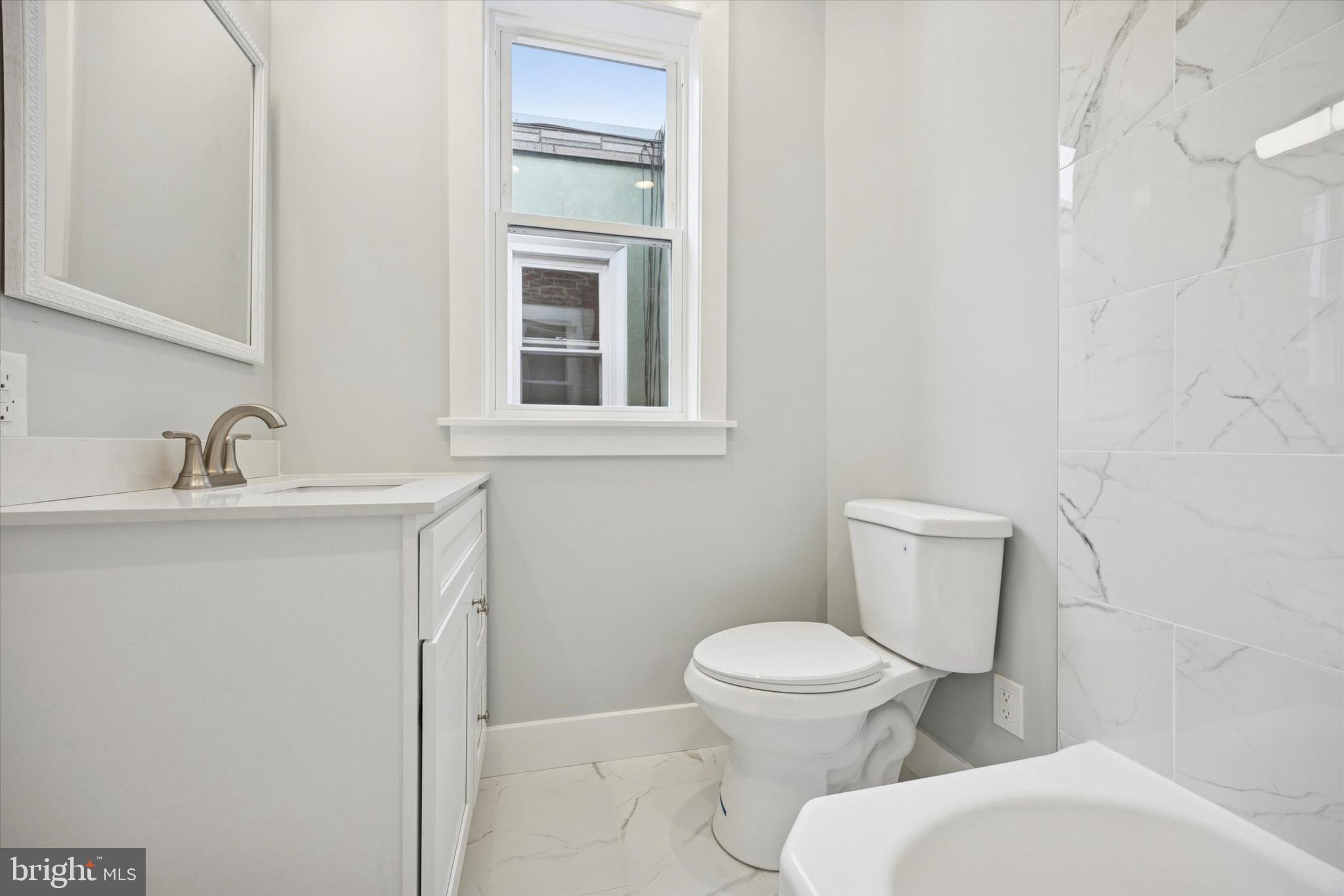 2869 Aramingo Avenue Philadelphia, PA 19134 - Photo 22 of 25 a white toilet sitting next to a bathroom sink