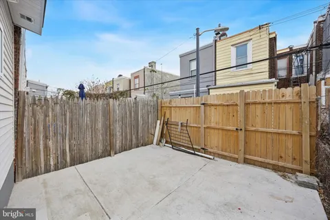 a view of a house with wooden fence