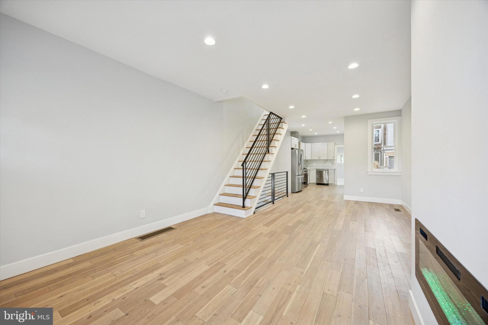 2869 Aramingo Avenue Philadelphia, PA 19134 - Photo 4 of 25 a view of an empty room with wooden floor and stairs