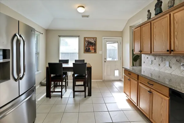 a kitchen with refrigerator cabinets and wooden floor