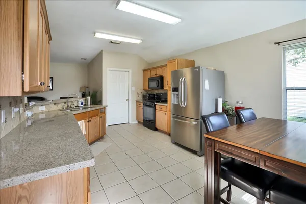a kitchen with stainless steel appliances granite countertop a sink and cabinets