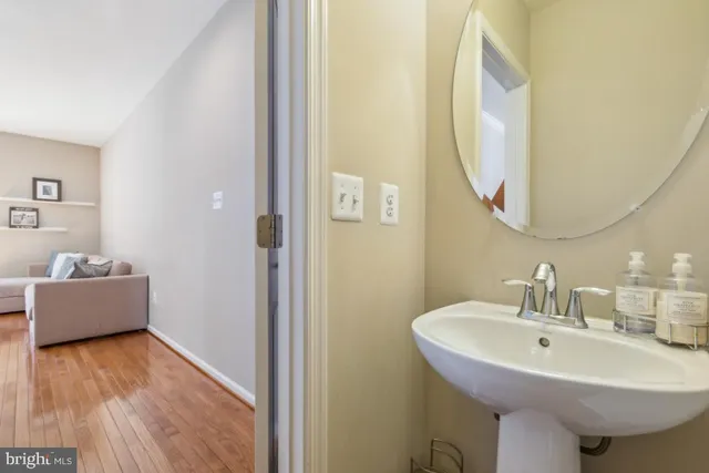 a bathroom with a sink a mirror and a bath tub