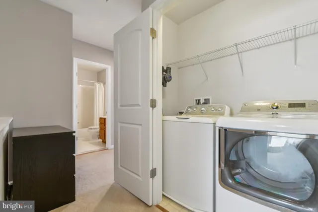 a utility room with cabinets washer and dryer