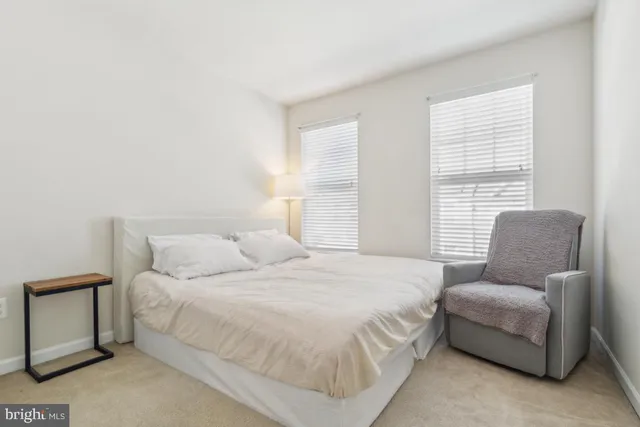 a bedroom with a bed and a couch with window