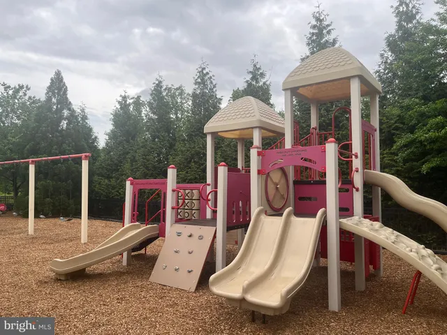 a view of a patio with a table chairs and a floor to ceiling window