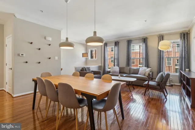 a view of a a dining room with furniture window and wooden floor