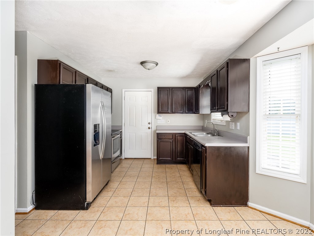 94 Robeson Street Spring Lake, NC 28390 - Photo 19 of 41 a kitchen with stainless steel appliances granite countertop a refrigerator and a sink