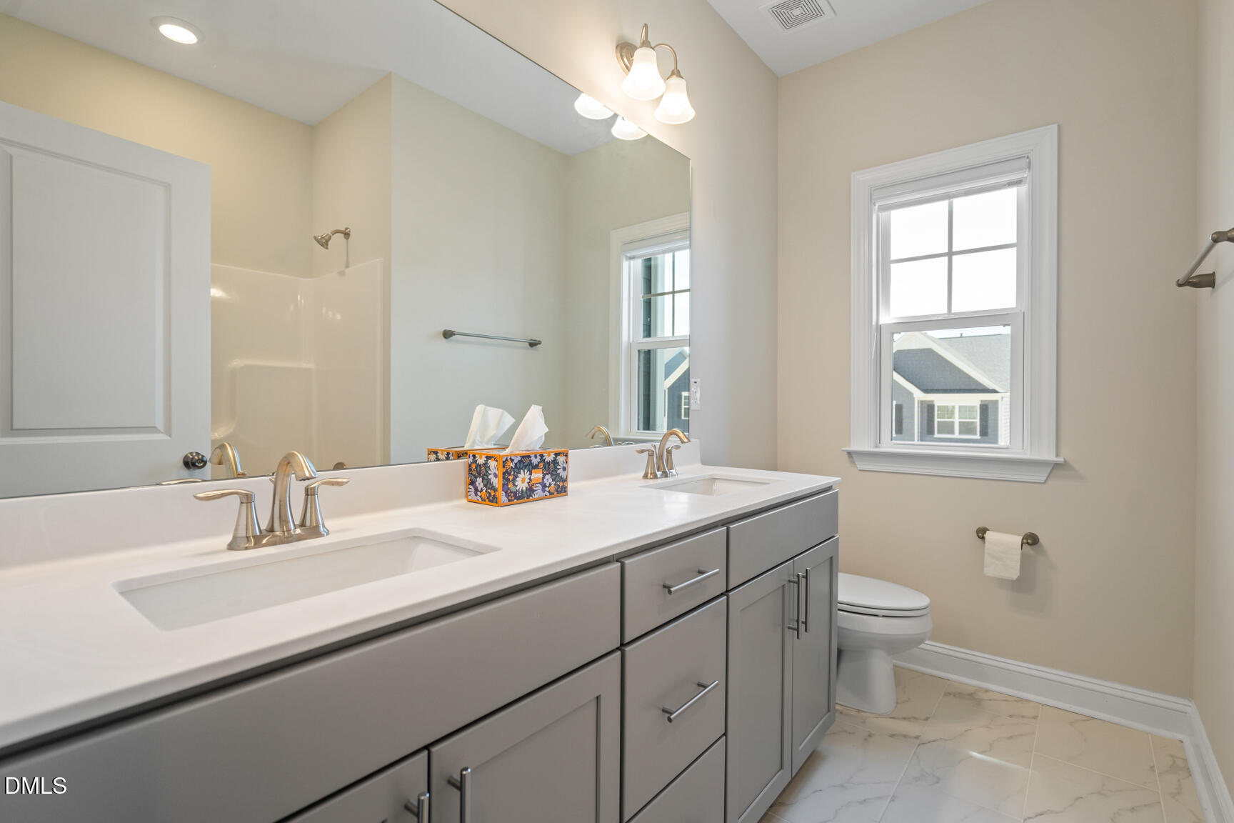 2966 Rise And Shine Road Apex, NC 27502 - Photo 44 of 61 a bathroom with a double vanity sink toilet and a mirror