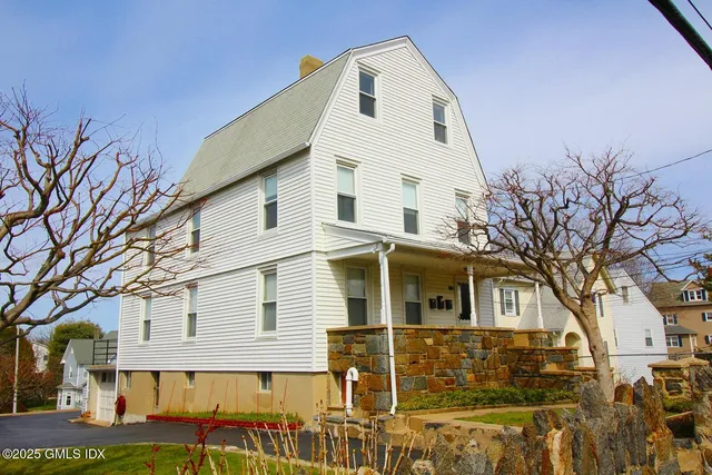 a view of a white house with a yard