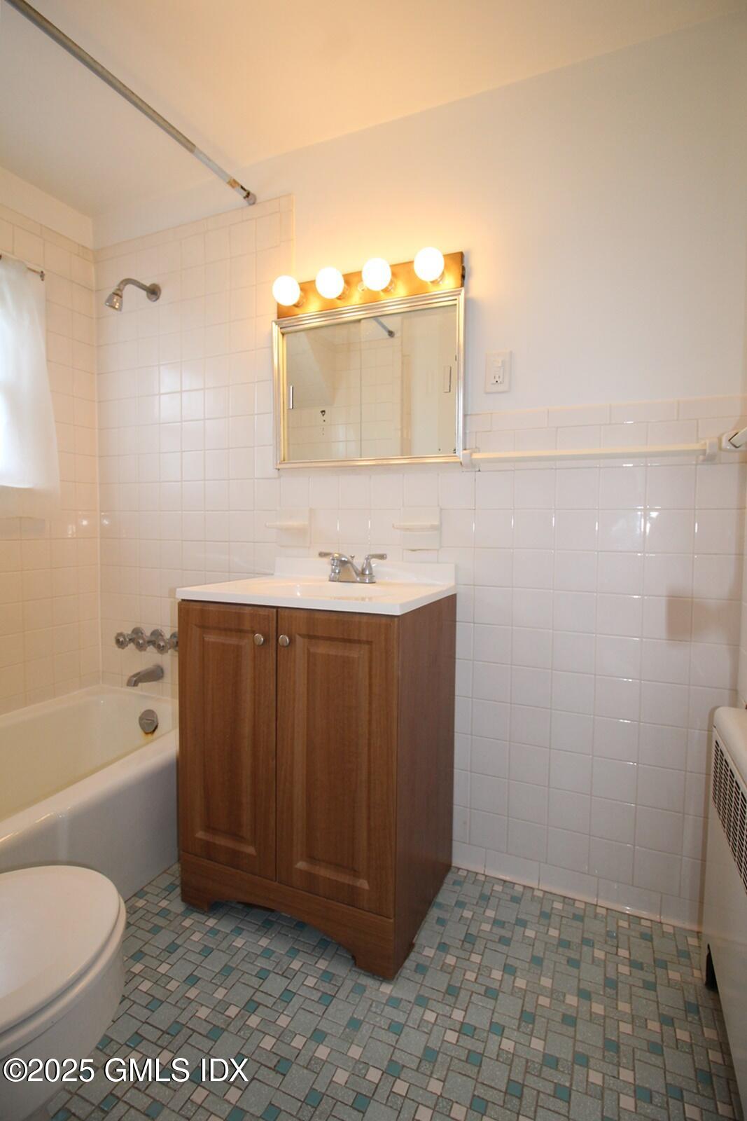 18 Harold Avenue, Unit B Greenwich, CT 06830 - Photo 6 of 9 a bathroom with a sink a toilet and shower