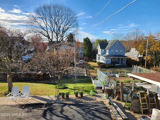 a view of a house with garden space and sitting area