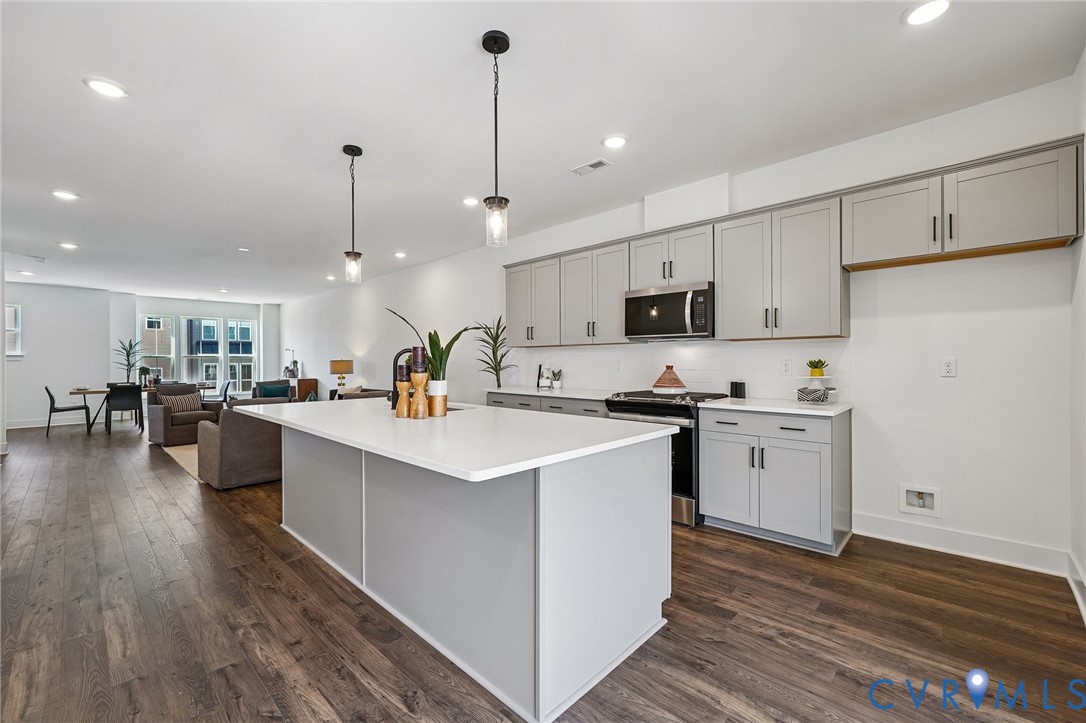 12042 Flowering Lavender Loop Henrico, VA 23233 - Photo 12 of 46 a kitchen with counter top space a sink appliances and cabinets