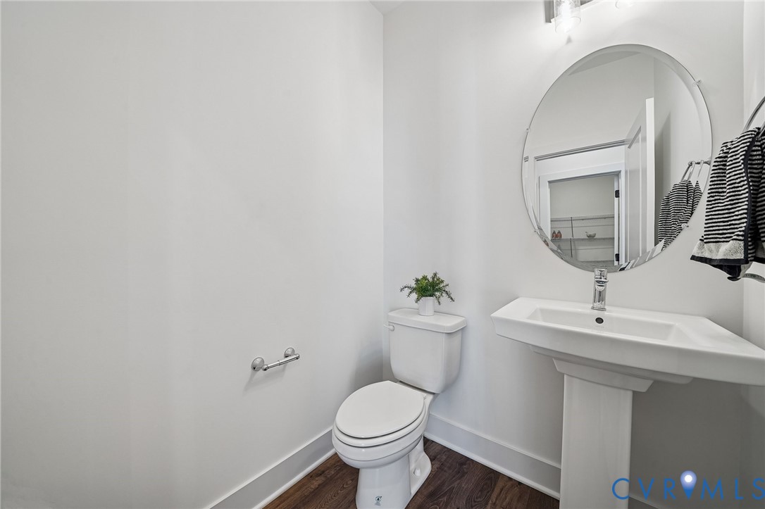 12042 Flowering Lavender Loop Henrico, VA 23233 - Photo 16 of 46 a bathroom with a toilet a sink and mirror