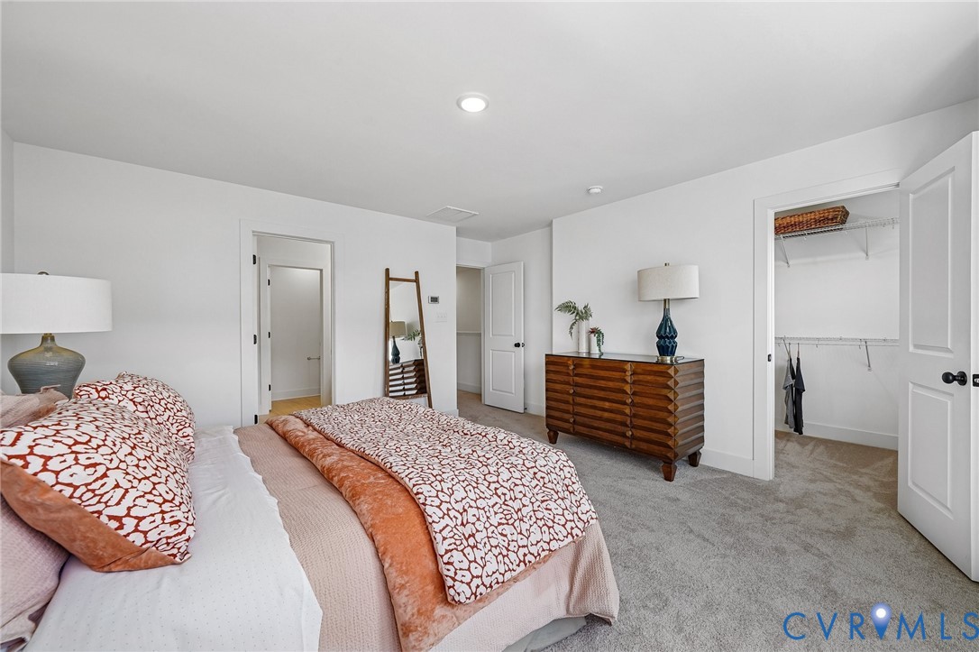12042 Flowering Lavender Loop Henrico, VA 23233 - Photo 23 of 46 a bedroom with a bed and walk in closet