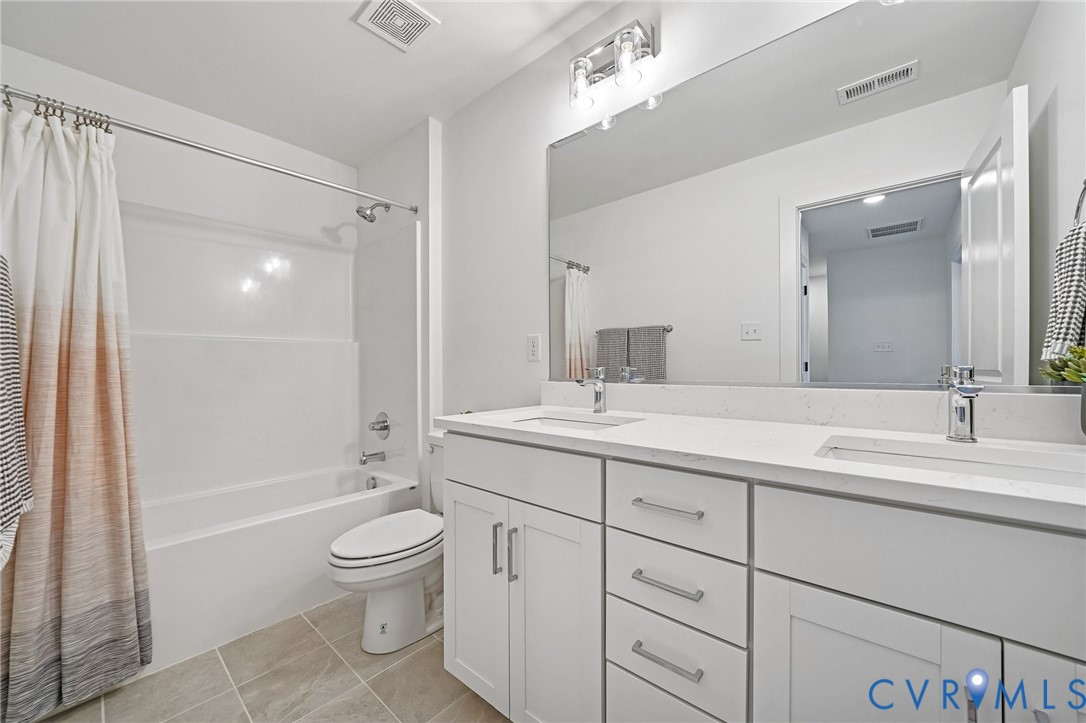 12042 Flowering Lavender Loop Henrico, VA 23233 - Photo 29 of 46 a bathroom with a toilet a sink and a large mirror