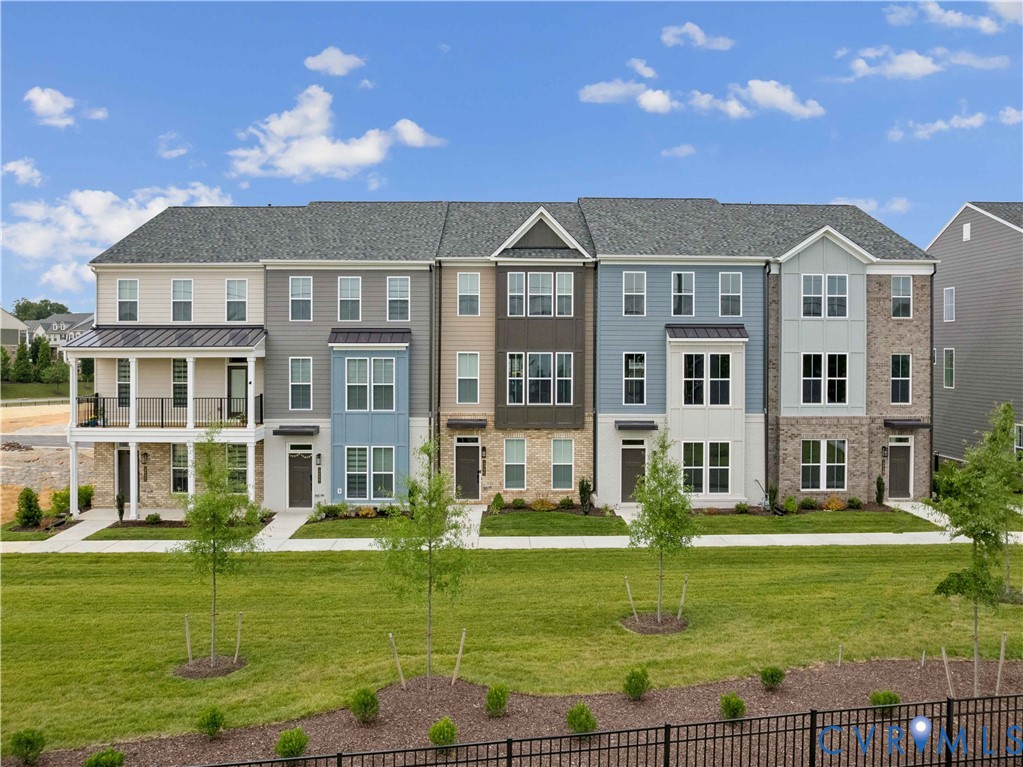 12042 Flowering Lavender Loop Henrico, VA 23233 - Photo 38 of 46 a front view of a residential apartment building with a yard