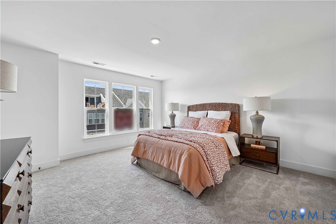 12042 Flowering Lavender Loop Henrico, VA 23233 - Photo 5 of 46 a spacious bedroom with a bed and a window